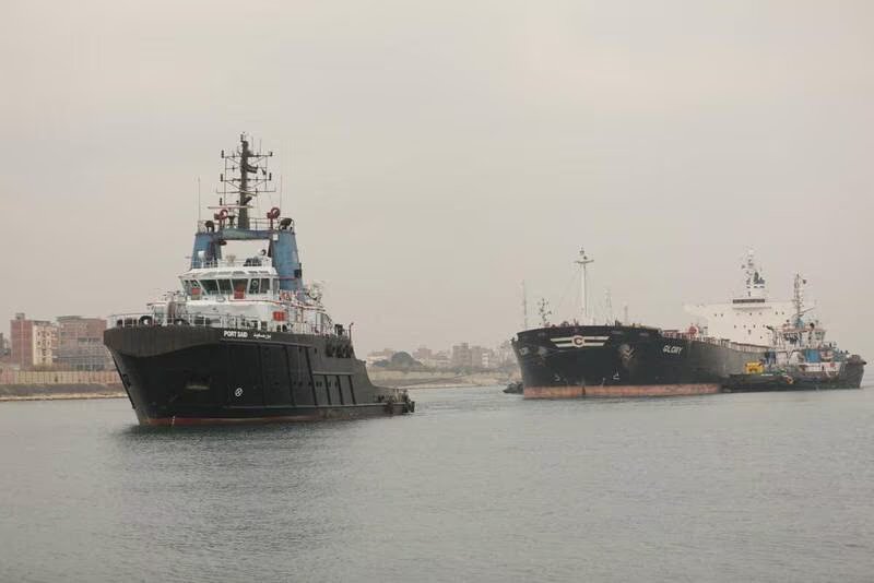 Suez Canal Authority tug boats tow the MV Glory after it recently became stuck in the waterway. File Photo / Reuters

