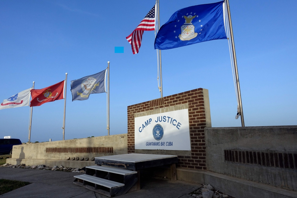 In this file photo taken on September 07, 2021, shows a sign for Camp Justice in Guantanamo Bay Naval Base, Cuba. (Photo by Paul Handley / AFP)