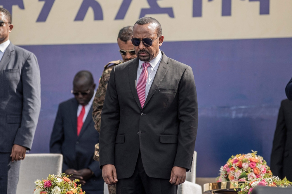 In this file photo taken on June 05, 2022 Abiy Ahmed, Prime Minister of Ethiopia, stands for a moment of silence during a ceremony of honoring members of the Federal Police Force in Addis Ababa, Ethiopia.  (Photo by Amanuel Sileshi / AFP)
 