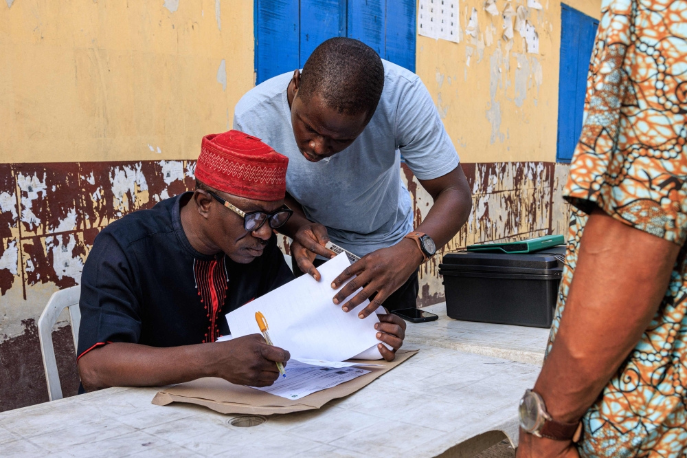 Independent National Electoral Commission (INEC) officials verify voters during a mock accreditation exercise organised by the INEC at Enitan Primary School at Surulere in Lagos, Nigeria, on February 4, 2023.  (Photo by Benson Ibeabuchi / AFP)