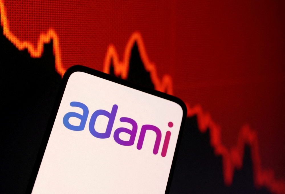 Adani logo and decreasing stock graph is seen in this illustration taken on January 31, 2023. REUTERS/Dado Ruvic/Illustration/File Photo