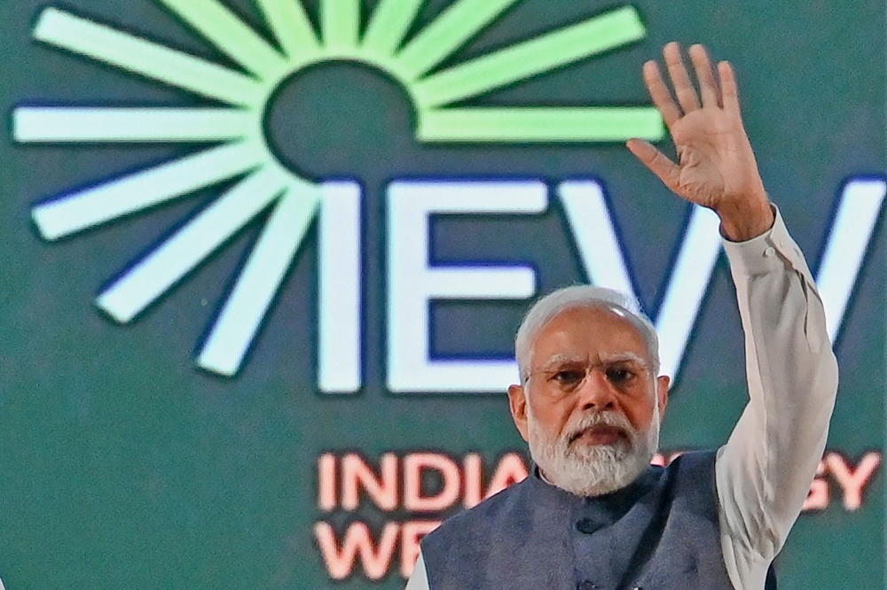India's Prime Minister Narendra Modi waves at the crowd during the inauguration of 'India Energy Week 2023' under India's G20 Presidency, in Bengaluru on February 6, 2023. (Photo by Manjunath KIRAN / AFP)