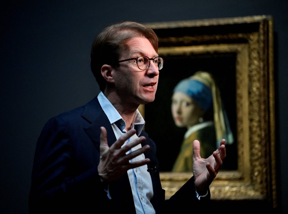 General Director of the Rijksmuseum Taco Dibbits speaks to journalists as he stands in front of a painting by the Dutch master Johannes Vermeer titled, 'Girl with a pearl earing' at the Rijksmuseum in Amsterdam on February 6, 2023. Photo by JOHN THYS / AFP