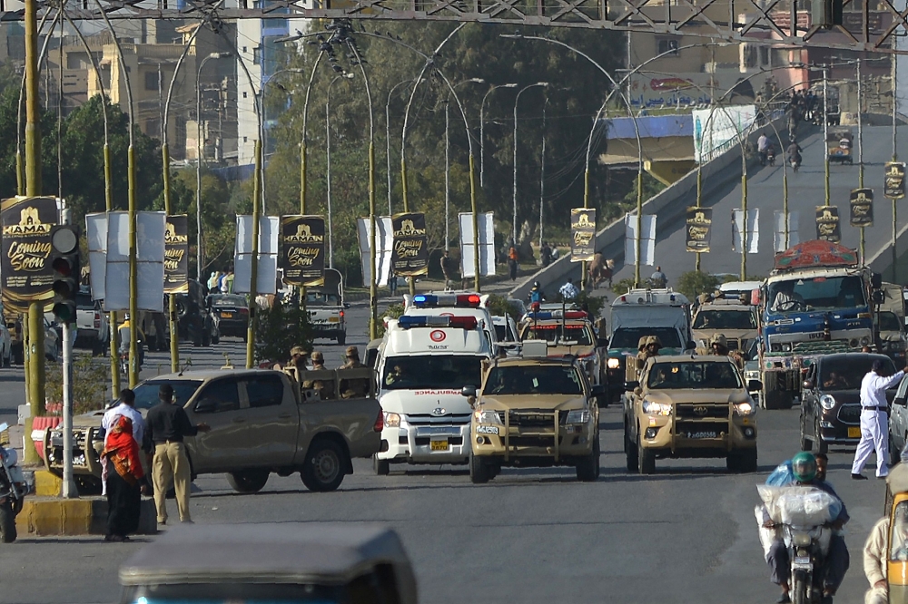 Army soldiers escort an ambulance carrying the coffin of Pakistan's former military ruler Pervez Musharraf after his funeral prayers while transporting his body to an army graveyard for burial in Karachi on February 7, 2023. (Photo by Rizwan Tabassum / AFP)