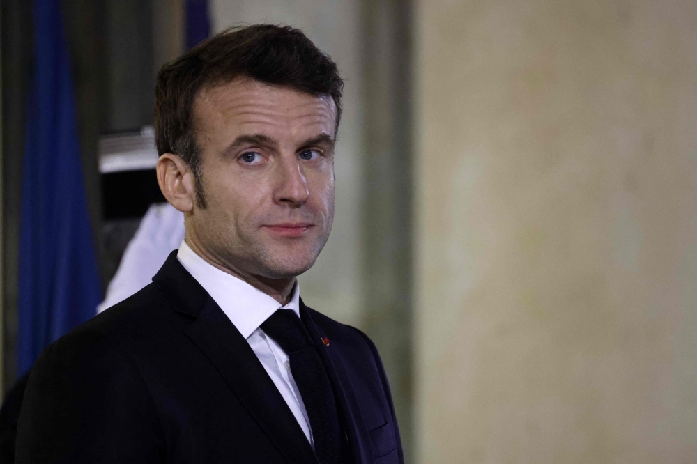 France's President Emmanuel Macron waits for Ethiopian Prime Minister before a meeting at the Elysee Presidential Palace in Paris on February 7, 2023. (Photo by Ludovic MARIN / AFP)