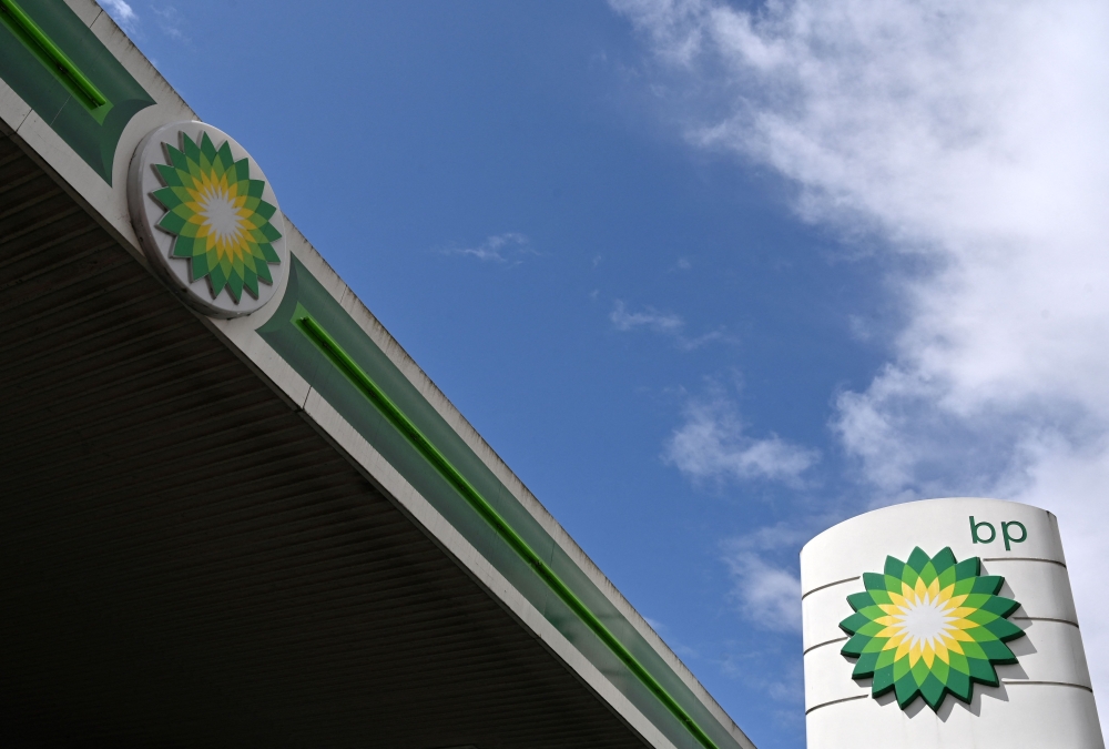 In this file photo taken on May 12, 2021 BP logos are pictured at a BP petrol and diesel filling station in north London. - British energy giant BP on February 7, 2023 announced a record profit for 2022 thanks to soaring oil and gas prices, as it watered down its target for cutting carbon emissions. BP's underlying profit more than doubled to a record $27.7 billion last year. (Photo by Glyn KIRK / AFP)