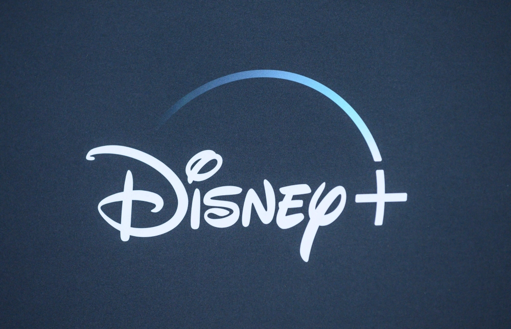 In this file photo taken on November 13, 2019 the Disney+ logo is seen on the backdrop for the World Premiere of 