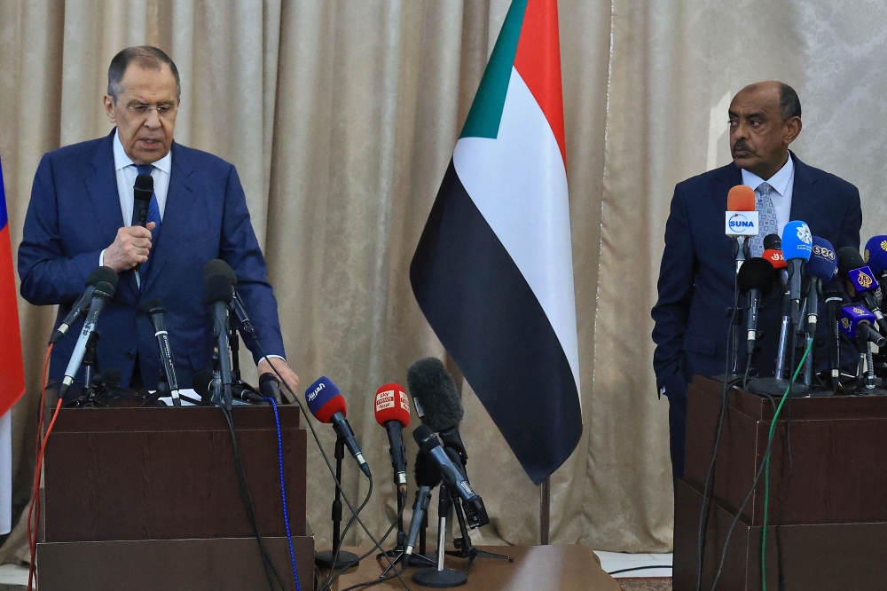 Russian Foreign Minister Sergei Lavrov (L) and Sudanese acting foreign minister Ali al-Sadiq (R) give a joint press conference at the airport in Khartoum on February 9, 2023 during an official visit to Sudan. (Photo by ASHRAF SHAZLY / AFP)