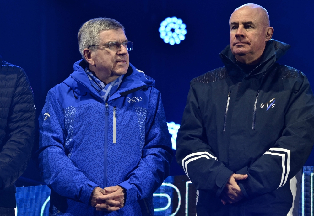 International Olympic Committee President (IOC) Thomas Bach (left) looks on during the award ceremony for the Women's Downhill event of the FIS Alpine Ski World Championship 2023 in Meribel, French Alps, on February 11, 2023. (Photo by Jeff PACHOUD / AFP)