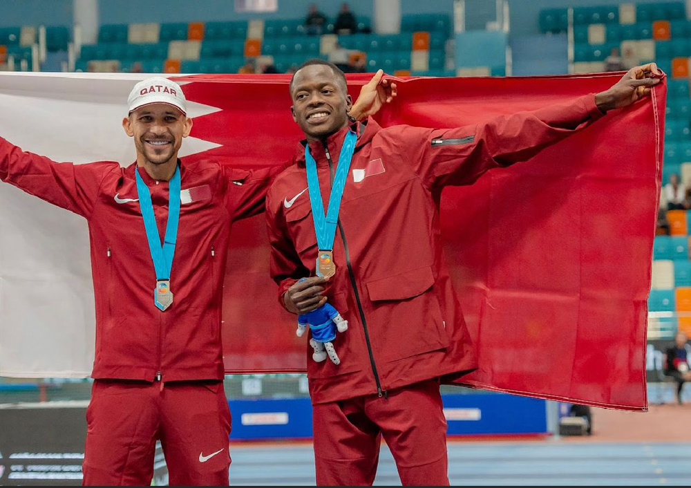 Mohammed Al Qarni and Musaab Adam celebrate after winning the silver and bronze medals respectively in the men's 1500m final.