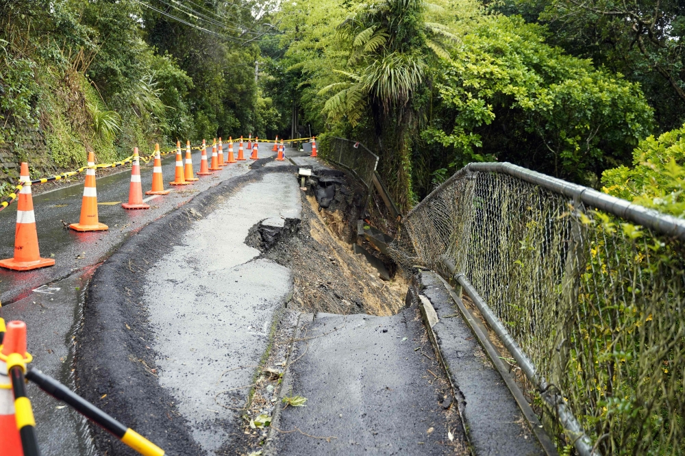 A general view of a damaged road after a storm battered Titirangi, a suburb of New Zealand's West Auckland area, on February 13, 2023. Photo by Diego OPATOWSKI / AFP
