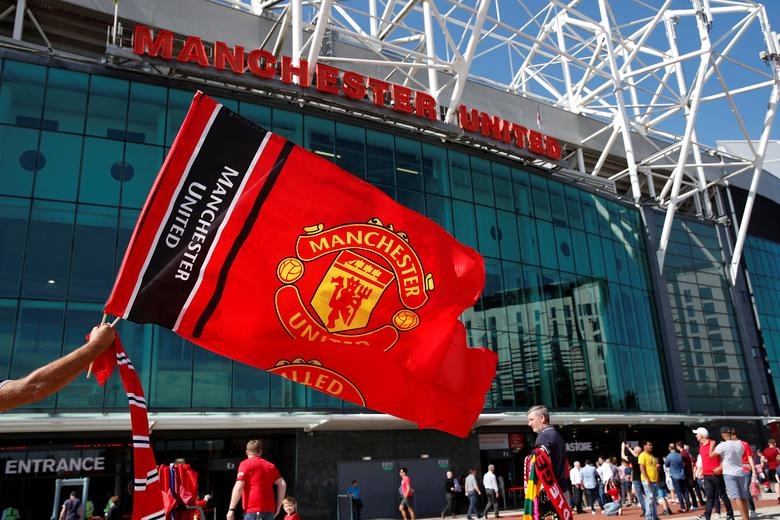 FILE PHOTO: Soccer Football - Premier League - Manchester United v Crystal Palace - Old Trafford, Manchester, Britain - August 24, 2019 General view as Manchester United fans wave a flag outside the stadium before the match Action Images via Reuters/Paul Childs
