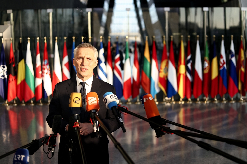 NATO Secretary General Jens Stoltenberg speaks to the press as he arrives for a two-day meeting of the alliance's Defence Ministers at the NATO headquarters in Brussels on February 14, 2023. (Photo by Kenzo TRIBOUILLARD / AFP)