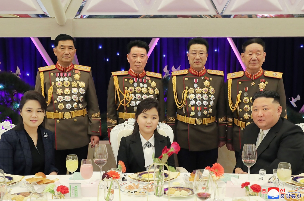 This picture taken on February 7, 2023 and released from North Korea's official Korean Central News Agency (KCNA) on February 8, 2023 shows North Korean leader Kim Jong Un attending a banquet to mark the 75th anniversary of the Korean People's Army (KPA), with his wife Ri Sol-Ju (left) and his daughter (centre) in North Korea. (Photo by KCNA VIA KNS / AFP)

