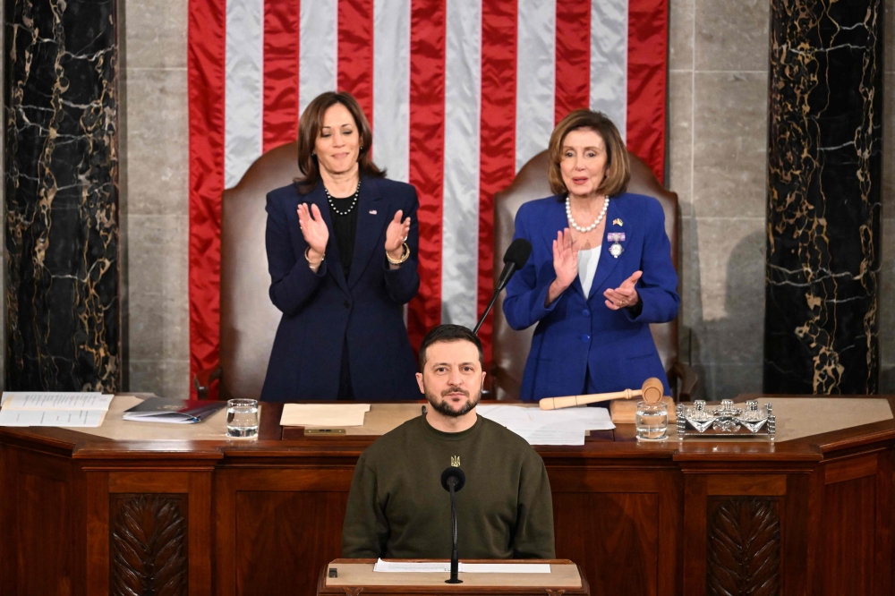 In this file photo taken on December 22, 2022 Ukraine's President Volodymyr Zelensky addresses the US Congress as US Vice President Kamala Harris (left) and US House Speaker Nancy Pelosi  applaud at the US Capitol in Washington, DC. (Photo by Jim WATSON / AFP)
