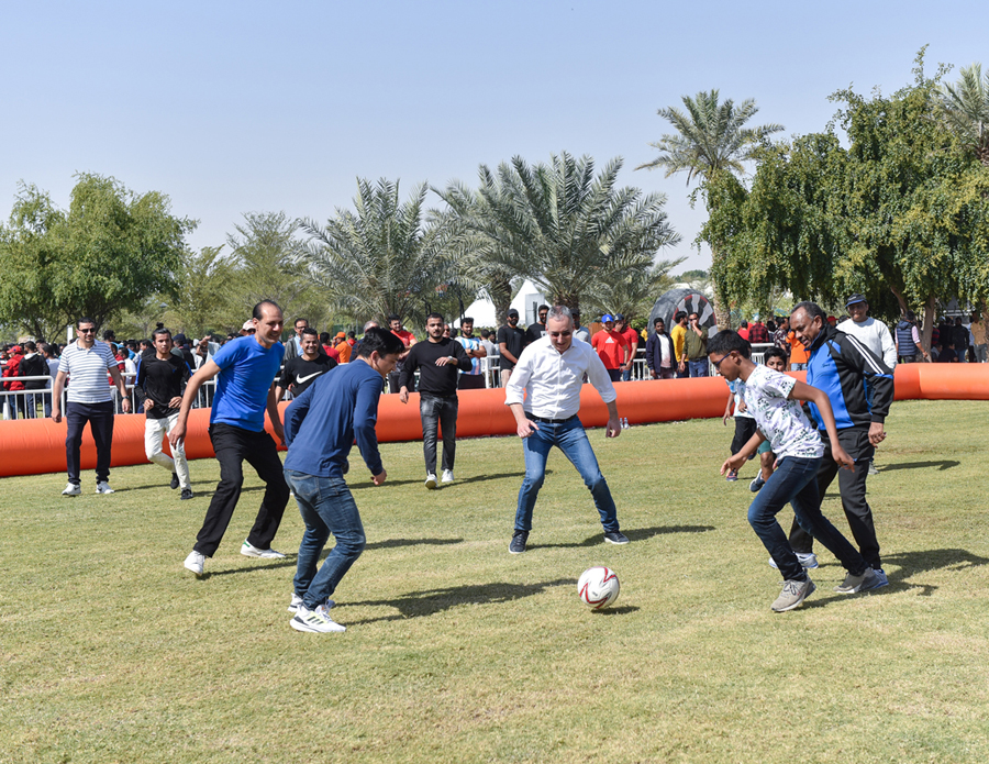 Mannai CEO and other officials taking part in a football match.