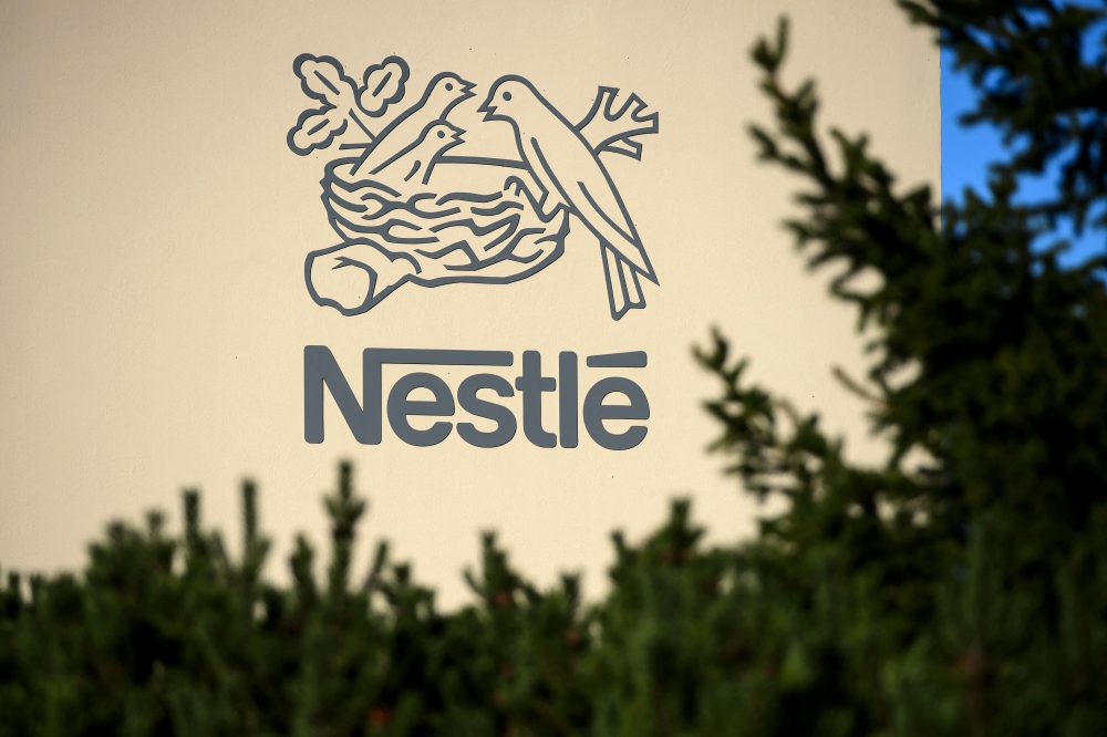 A logo of the world's leading food industry group Nestle is seen on October 9, 2014 at the group's Research Center in Vers-chez-les-Blanc above Lausanne. (Photo by Fabrice Coffrini / AFP)