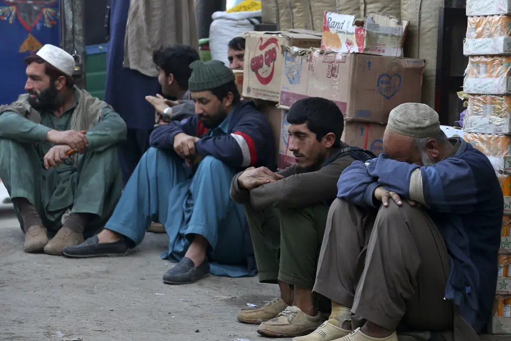 Daily wage labourers wait for work at a market in Peshawar, Pakistan, on February 17, 2023. (AP Photo/Muhammad Sajjad)