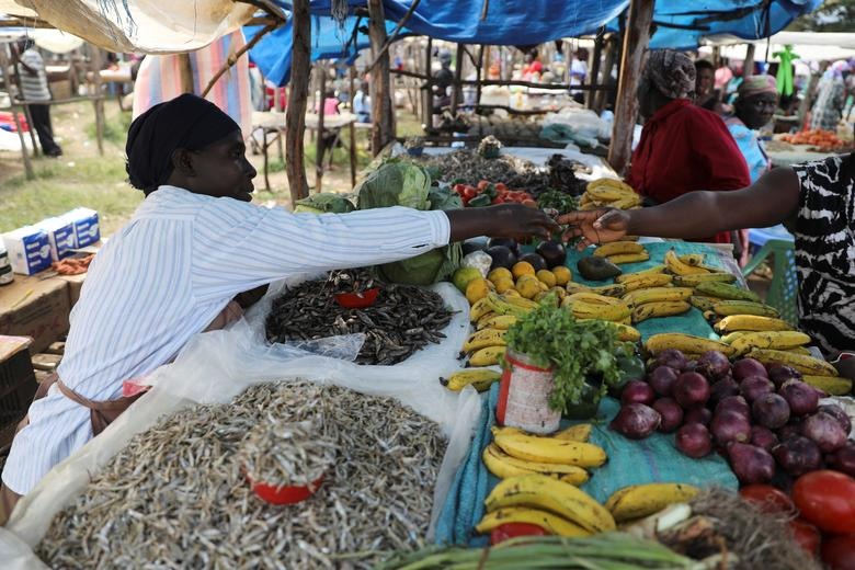 Luo shop owner Caroline Otieno sells fish that come from Lake Victoria in Kisumu county and fruits from Nandi county, at a market stall in the town of Chemase, Nandi county, Kenya August 1, 2022. REUTERS/Baz Ratner