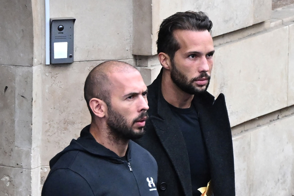 (FILES) This file photo taken on January 10, 2023 shows British-US former professional kickboxer and controversial influencer Andrew Tate (L) and his brother Tristan Tate (R) exiting a court in Bucharest, Romania. (Photo by Daniel MIHAILESCU / AFP)