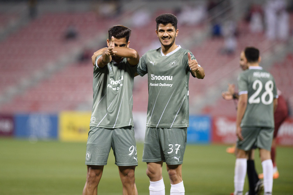 Rami Suhail celebrates with a team-mate after scoring Al Arabi's opening goal. 