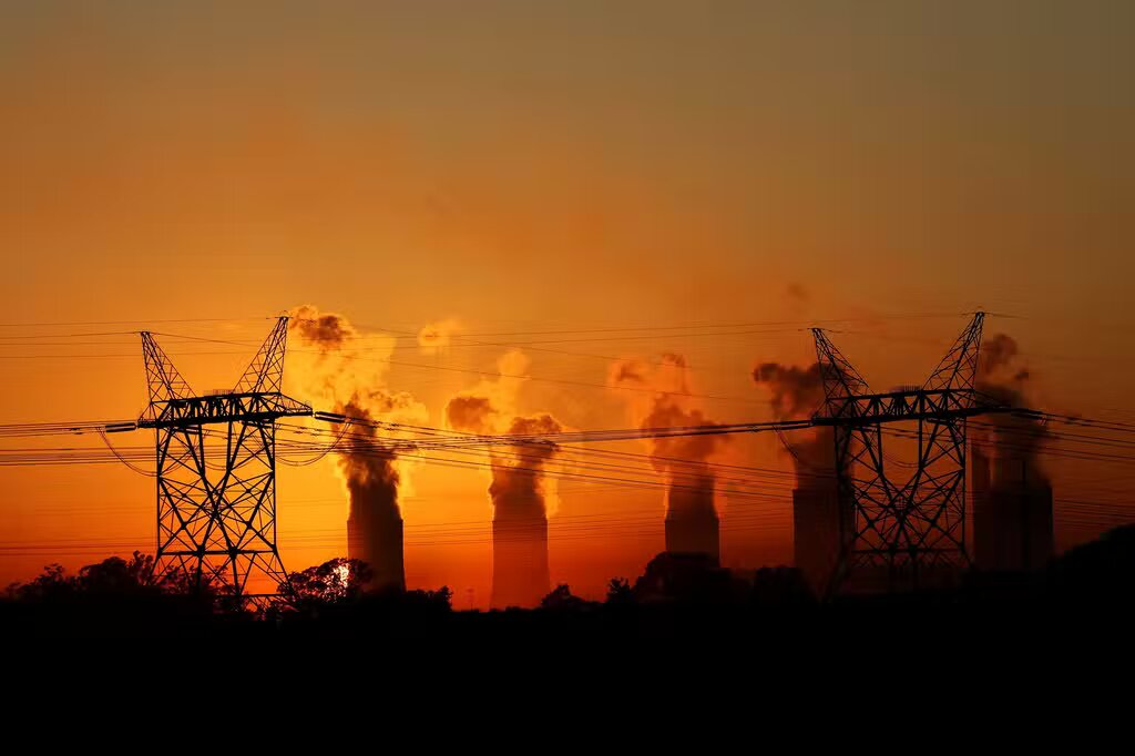 Electricity pylons in front of cooling towers at an Eskom coal-burning power station near Sasolburg in the northern Free State province.
