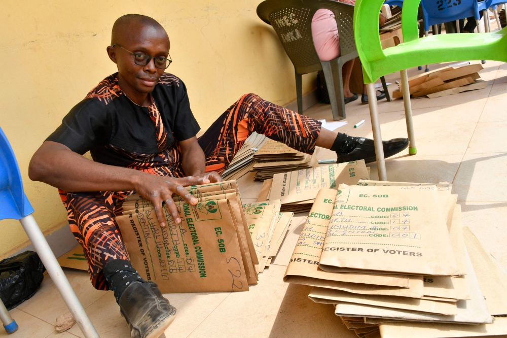 An official of Independent National Electoral Commission (INEC) prepares document ahead of the February 25 presidential election at the commission's headquarters at Awka in Anambra State, southeast Nigeria, on February 16, 2023. (Photo by Pius Utomi Ekpei / AFP)