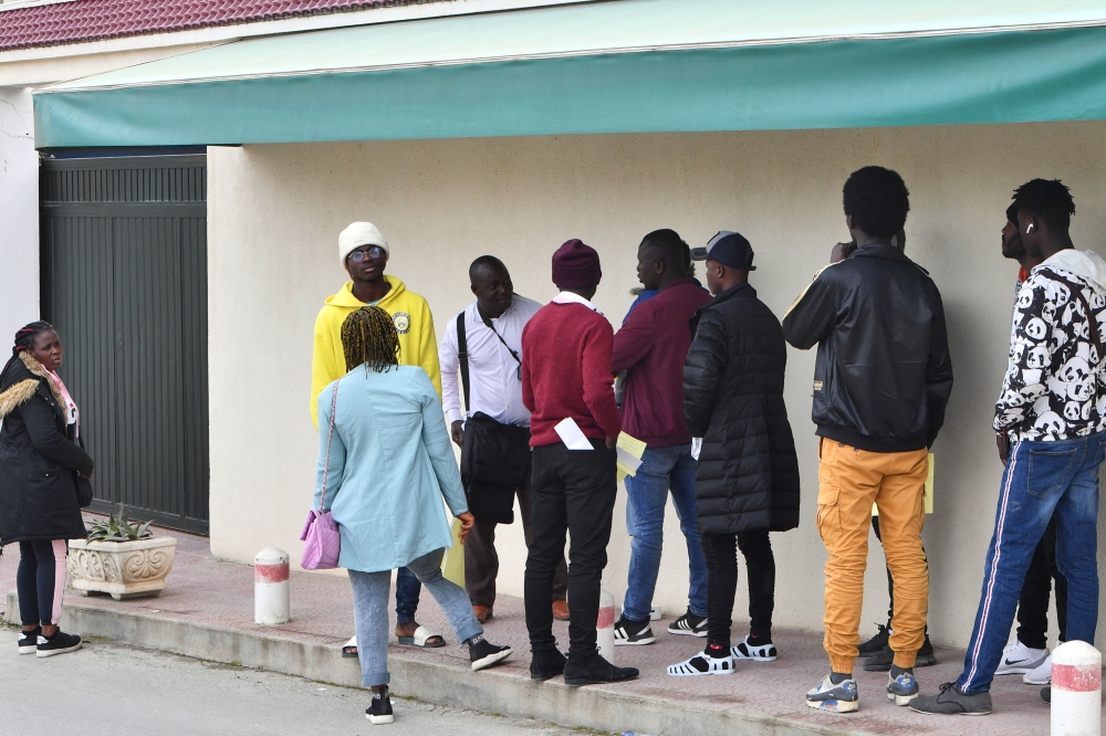 Ivorians gather in front of the Ivory Coast embassy for their repatriation to Abidjan, on February 24, 2023 in Tunis. - Tunisian President Kais Saied called the previous for his government to take care of 