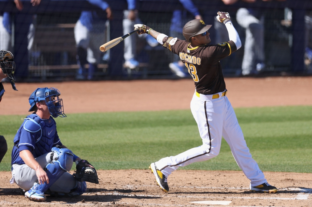 PEORIA, ARIZONA - FEBRUARY 27: Manny Machado #13 of the San Diego Padres hits a single against the Los Angeles Dodgers during the third inning of the spring training game at Peoria Stadium on February 27, 2023 in Peoria, Arizona. Christian Petersen/Getty Images/AFP
