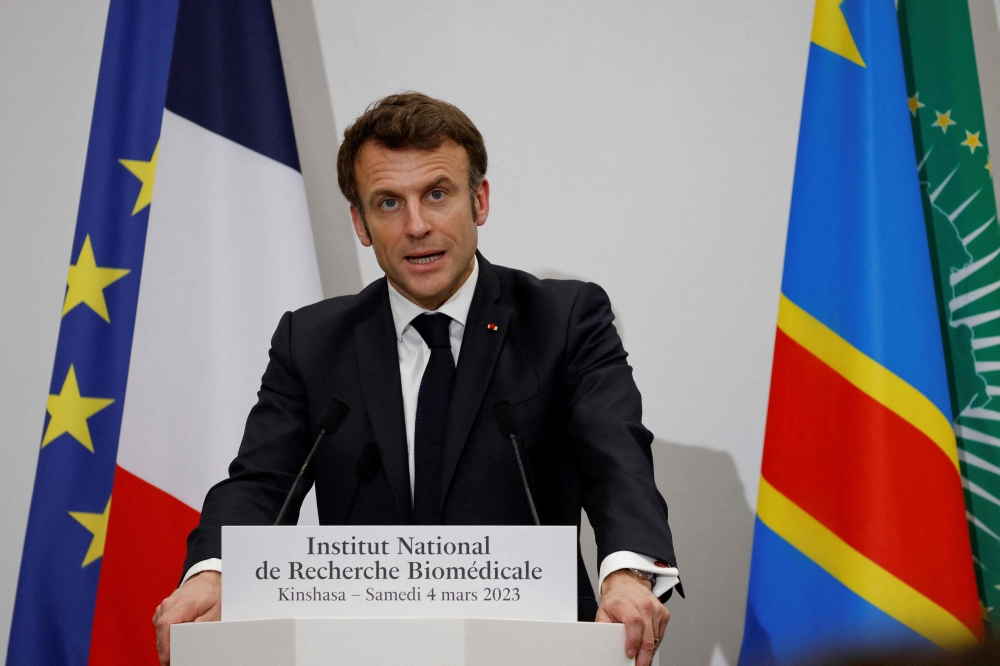France's President Emmanuel Macron delivers a speech during a visit at the National Biomedical Research Institute (NBRI) in Kinshasa on March 4, 2023. - The French President is in Kinshasa on the fourth and last leg of an African tour. (Photo by LUDOVIC MARIN / AFP)