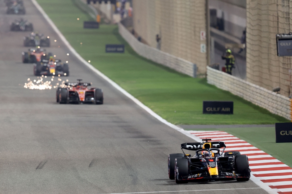 Red Bull Racing's Dutch driver Max Verstappen (right) leads the race ahead of Ferrari's Monegasque driver Charles Leclerc during the Bahrain Formula One Grand Prix at the Bahrain International Circuit in Sakhir on March 5, 2023. (Photo by Giuseppe CACACE / AFP)