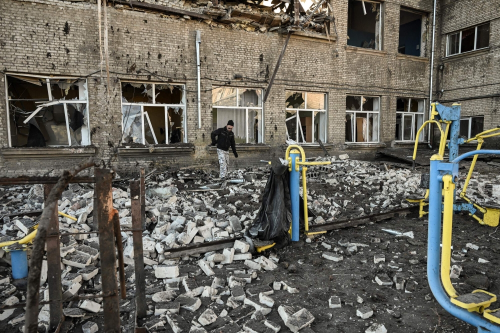A man walks outside a destroyed school after a missile strike in Kramatorsk, Dombass regions, on March 6, 2023, amid Russian invasion of Ukraine. (Photo by Aris Messinis / AFP)
 