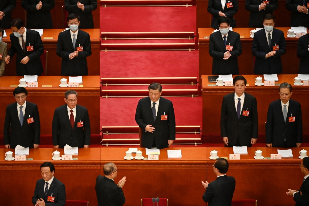 China's President Xi Jinping (centre) is applauded as he arrives for the second plenary session of the National People's Congress (NPC) at the Great Hall of the People in Beijing on March 7, 2023. (Photo by Greg Baker / AFP)
 