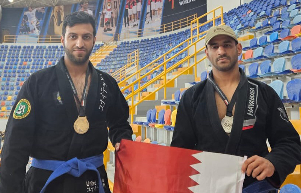 Qatar's medal-winning athletes pose with the national flag.