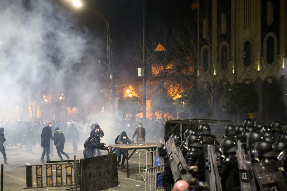 Protesters clash with police in Tbilisi late on March 8, 2023. (Photo by Zurab Tsertsvadze / AFP)
 