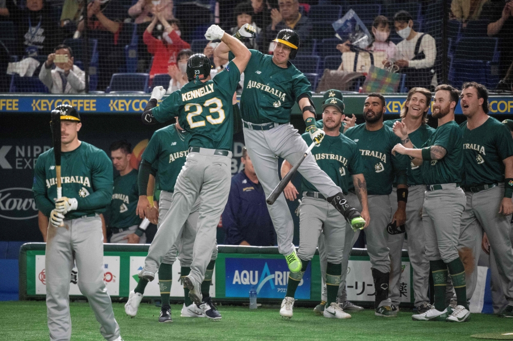 Australia's Timothy Kennelly (centre L) celebrates with teammates after hitting a home run during the World Baseball Classic (WBC) Pool B round game between Australia and South Korea at the Tokyo Dome in Tokyo on March 9, 2023. (Photo by Richard A. Brooks / AFP)