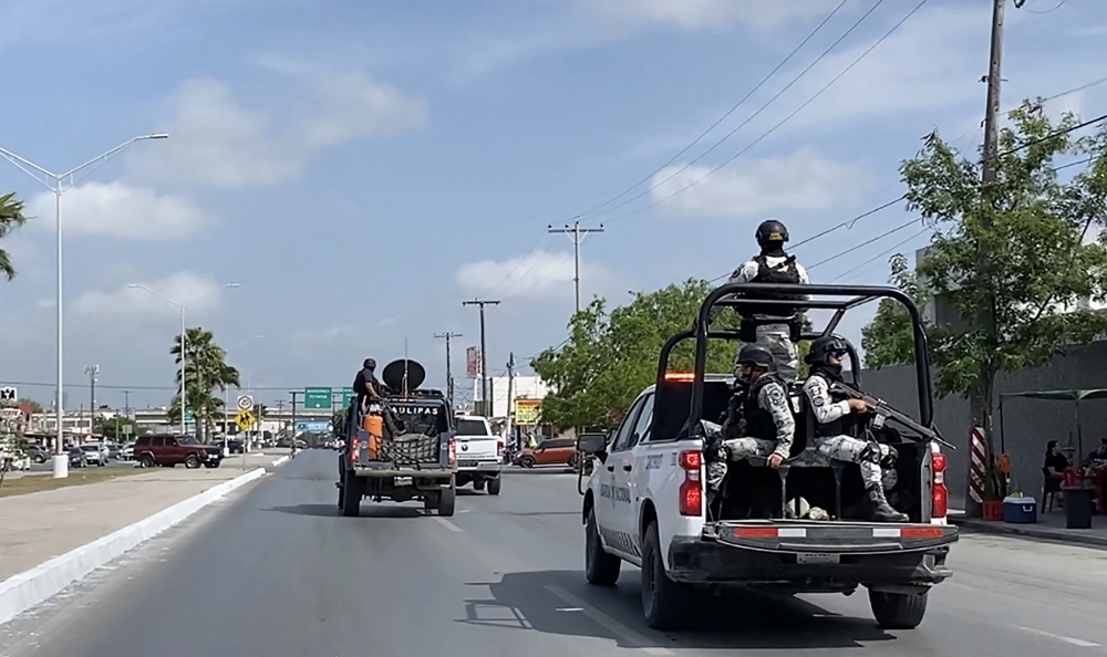 In this file photo taken on March 07, 2023 National Guard and military vehicles take part in an operation to transfer two of the four US citizens kidnapped in Mexico's crime-ridden northeast, back to Brownsville in the US, after the other two were found dead, in Matamoros, Tamaulipas State, Mexico.  (Photo by AFP)
