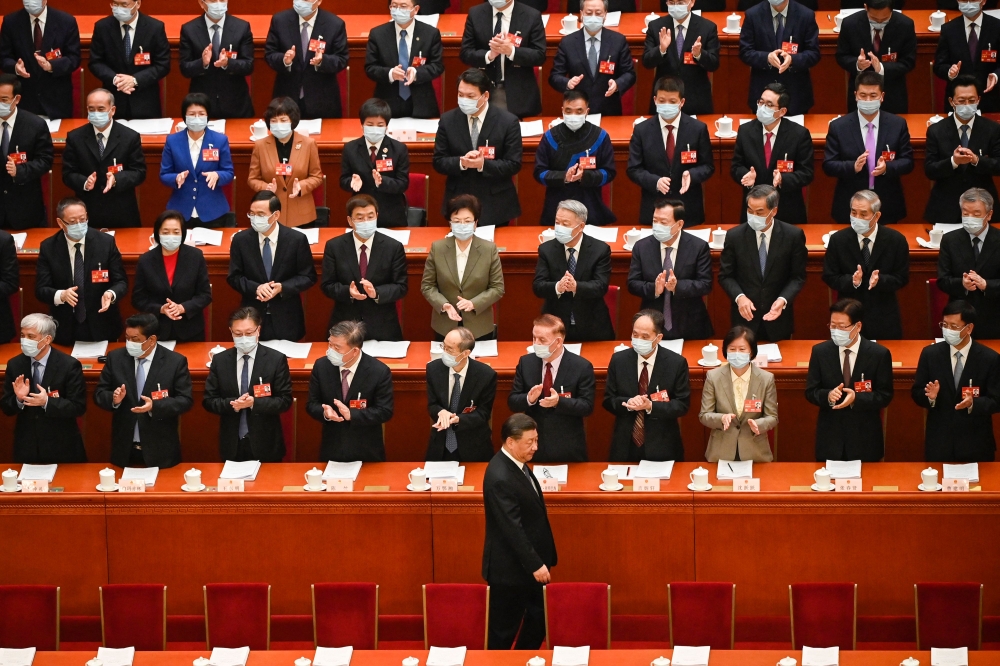 In this file photo taken on March 06, 2023 China's President Xi Jinping (bottom) arrives for the second plenary session of the National People's Congress (NPC) with other Chinese leaders at the Great Hall of the People in Beijing.  (Photo by Greg Baker / AFP)