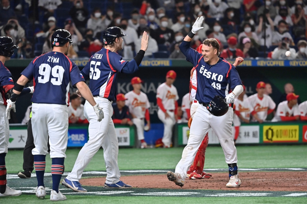 Czech Republic's Martin Muzik (R) celebrates as he crosses home plate after hitting a three-run homer during the World Baseball Classic (WBC) Pool B round game between the Czech Republic and China at the Tokyo Dome in Tokyo on March 10, 2023. (Photo by Kazuhiro NOGI / AFP)