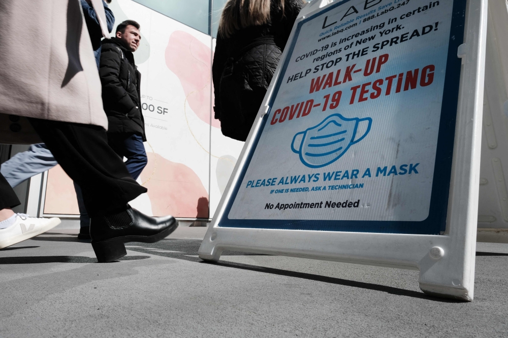 A sign for a Covid-19 testing tent sits along a Manhattan street on March 09, 2023 in New York City. (Photo by Spencer Platt / Getty Images via AFP)