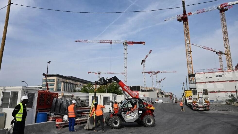 Workers operate at the site of the 2024 Olympic and Paralympic Games athletes' village in Saint-Ouen, outside Paris, on 30 August, 2022. File photo / AFP 