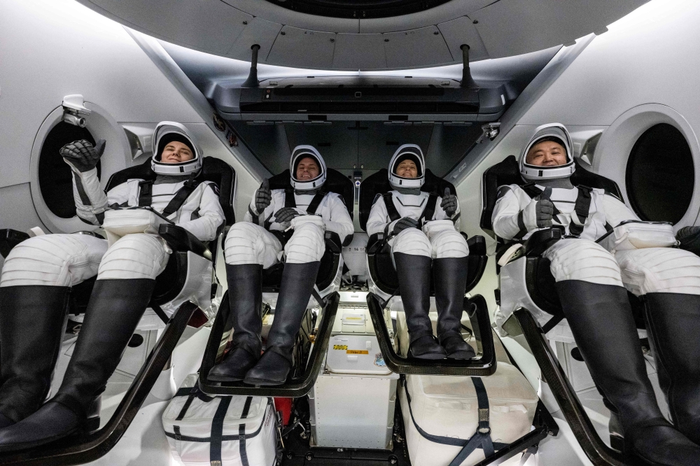 This NASA handout photo shows (L-R) Roscosmos cosmonaut Anna Kikina, NASA astronauts Josh Cassada and Nicole Mann, and Japan Aerospace Exploration Agency (JAXA) astronaut Koichi Wakata inside the SpaceX Dragon Endurance spacecraft onboard the SpaceX recovery ship Shannon shortly after having landed in the Gulf of Mexico off the coast of Tampa, Florida, March 11, 2023. Photo by Keegan Barber / NASA / AFP