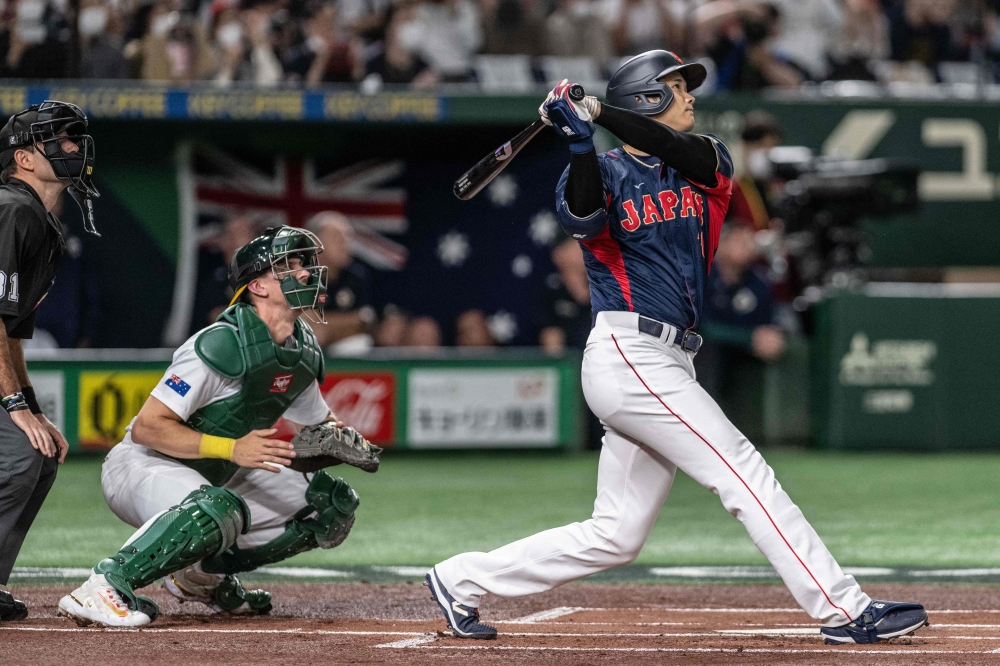 Japan's Shohei Ohtani hits a three-run home run during the World Baseball Classic (WBC) Pool B round game between Japan and Australia at the Tokyo Dome in Tokyo on March 12, 2023. (Photo by Yuichi YAMAZAKI / AFP)