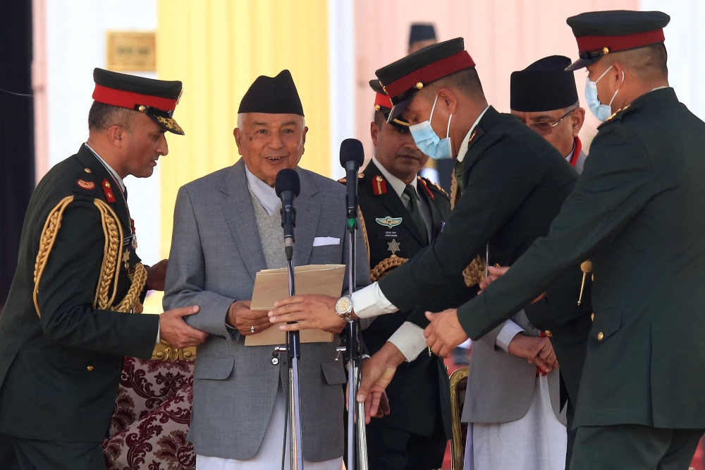 Nepal's newly elected President Ram Chandra Poudel (second left) takes oath of office at the presidential house in Kathmandu on March 13, 2023. (Photo by Dipesh Shrestha / AFP)