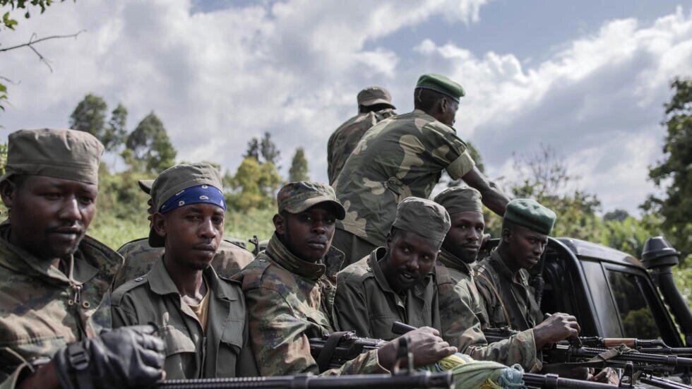 M23 rebels attending ceremonies at Rumangabo on January 6 when they handed back an army base they had seized. Guerchom Ndebo / AFP
