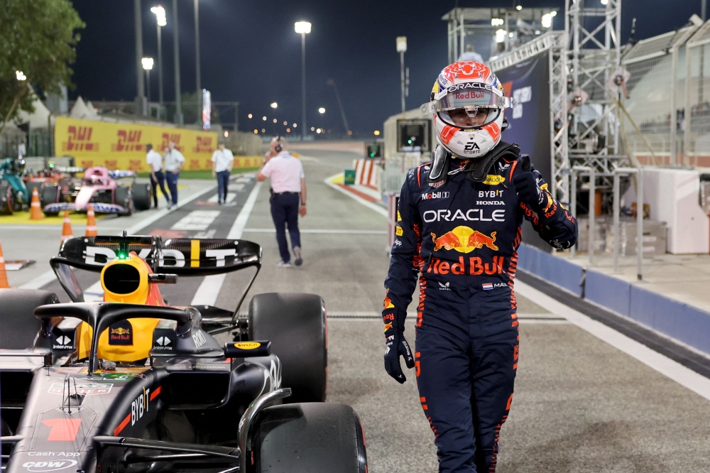 Red Bull Racing's Dutch driver Max Verstappen gives the thumbs-up gesture as he walks by his car in the pit lane during the qualifying round of the Bahrain Formula One Grand Prix at the Bahrain International Circuit in Sakhir on March 4, 2023. (Photo by Giuseppe CACACE / AFP)

