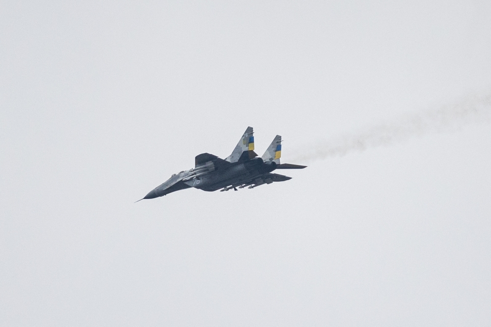 This file photo taken on January 1, 2023 shows a MIG-29 Ukrainian fighter jet flying over eastern Ukraine. - Slovakia will donate 13 MiG-29 warplanes to Ukraine, the Slovak prime minister said on March 17, 2023, making it the second NATO member to announce such a shipment following a similar move by Poland. (Photo by Sameer Al-DOUMY / AFP)
 