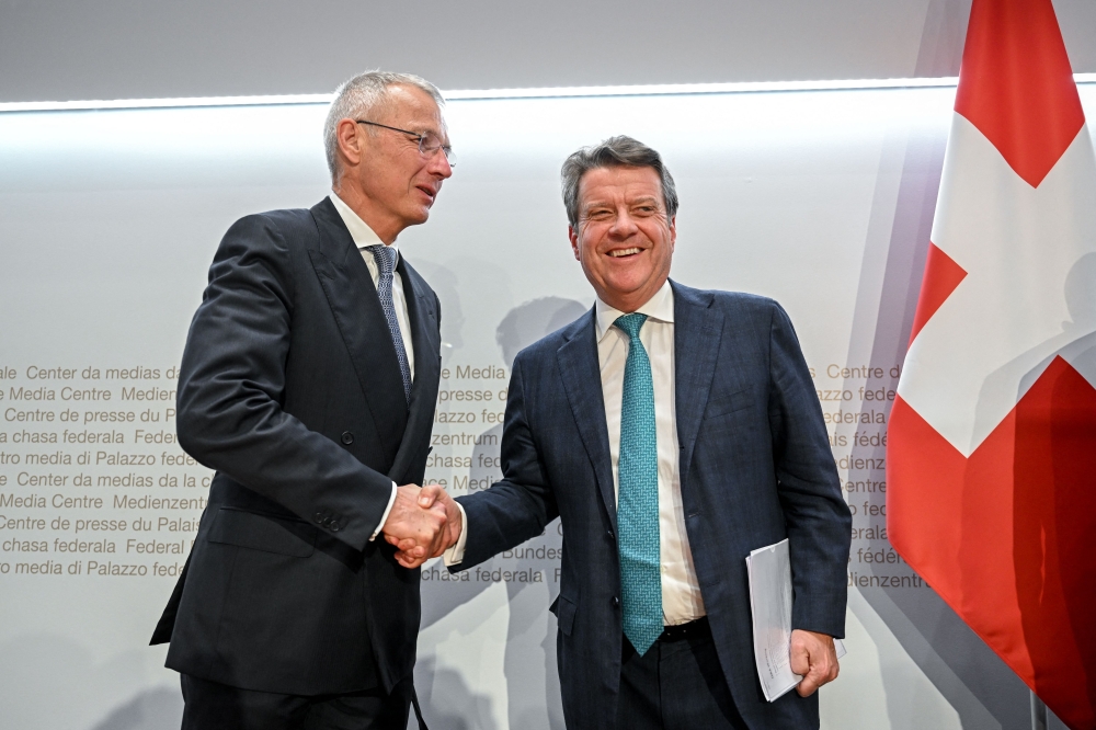 UBS Chairman Colm Kelleher (R) shakes hands with Credit Suisse chairman Axel Lehmann (L) after a press conference following talks over Credit Suisse in Bern on March 19, 2023.