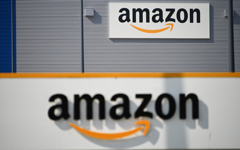 In this file photo taken on April 16, 2020 A picture shows the Amazon logo at the entrance area of the Amazon logistics centre in Lauwin-Planque, northern France, on April 16, 2020.  (Photo by DENIS CHARLET / AFP)
