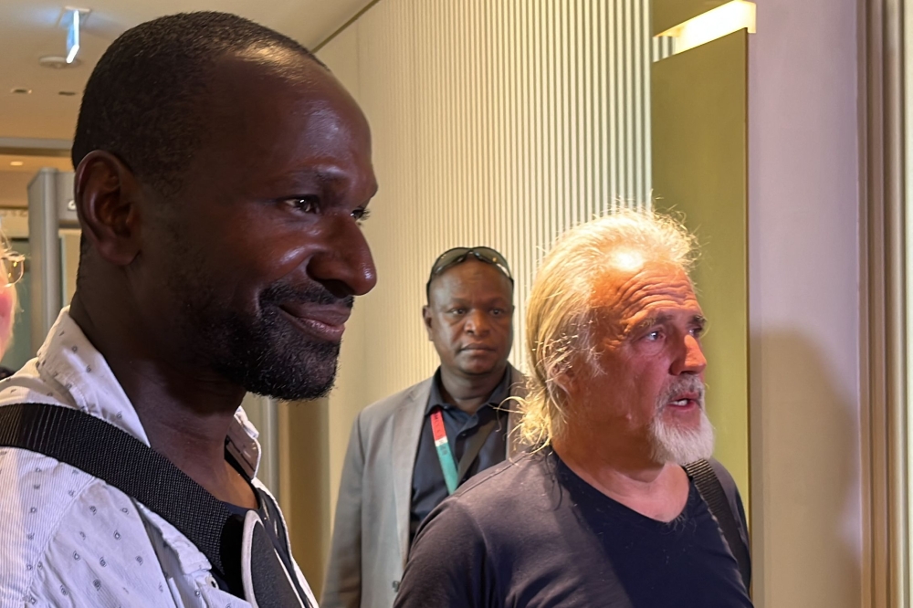 French journalist Olivier Dubois (left), freed nearly two years after he was kidnapped by the Support Group for Islam and Muslims (GSIM) in Mali, and US national Jeffery Woodke (right), freed after being kidnapped in October 2016 in Niger, are seen as they arrive at the Diori Hamani International Airport in Niamey on March 20, 2023. (Photo by Souleymane AG ANARA / AFP)